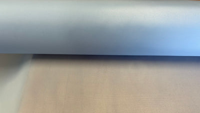 Up close photo of roll of light blue peel ply vacuum bagging material.