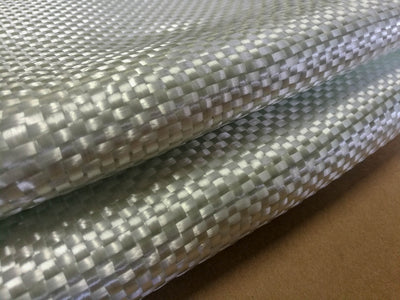 Folded woven roving fiberglass fabric sitting on table.